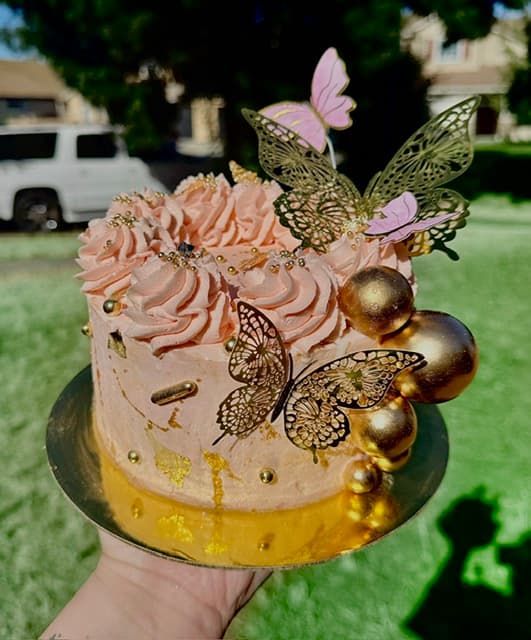 Custom butterfly celebration cake with gold and pink butterfly decorations