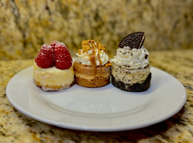 Three mini cheesecakes with assorted toppings