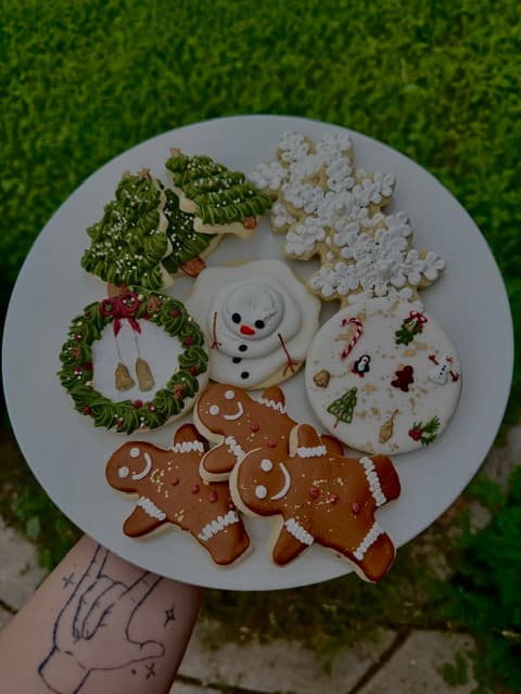 Assorted decorated Christmas cookies arranged on a white plate