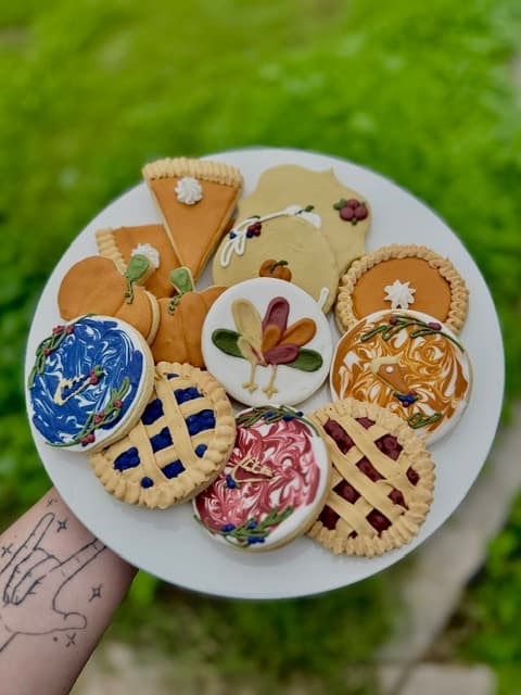 Assorted decorated Thanksgiving cookies with pie, turkey, leaf, and pumpkin designs